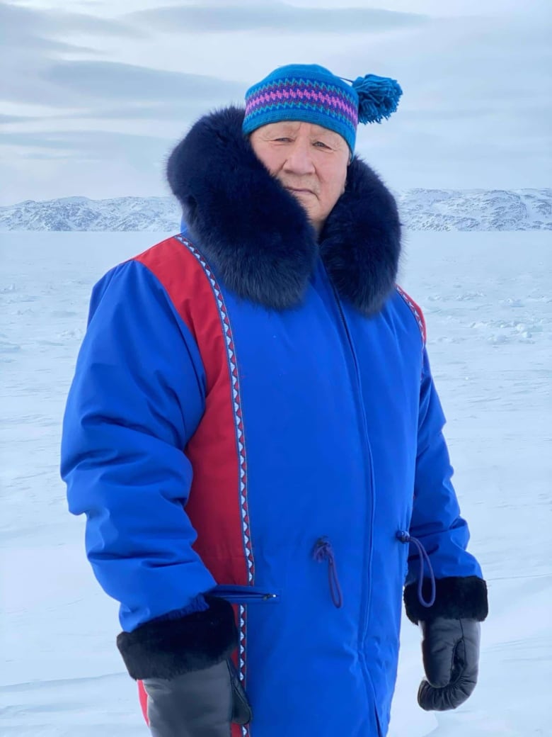 Charlie Arngak stands outside in parka and winter hat